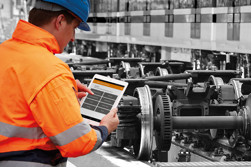 Man documents maintenance activities on rail vehicles on the tablet